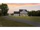 Charming two-story home with a spacious lawn and inviting front porch, perfect for relaxing evenings at 3805 Euliss Rd, Burlington, NC 27215