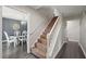 Hallway with staircase leading upstairs, adjacent to an elegant dining room with modern chandelier at 3805 Euliss Rd, Burlington, NC 27215