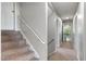 Bright hallway features carpeted stairs with white handrail and doorway to exercise room at 3805 Euliss Rd, Burlington, NC 27215