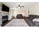 Open living room features stone fireplace, tv, reclining loveseat and large decorative area rug at 3805 Euliss Rd, Burlington, NC 27215