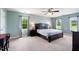 Calming main bedroom featuring carpet floors, a ceiling fan, and three windows for natural light at 3805 Euliss Rd, Burlington, NC 27215