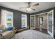 Spacious playroom featuring two large windows, dark wood floors, and access to the home at 3805 Euliss Rd, Burlington, NC 27215