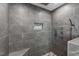 The large walk-in shower features gray tiling, stone pebble floor and shower controls at 3805 Euliss Rd, Burlington, NC 27215