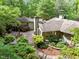 Overhead view of the backyard, showcasing the brick patio, stone pathway, and lush landscaping surrounding the home at 3915 Nottaway Rd, Durham, NC 27707