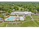 Stunning aerial view of clubhouse with pool, golf course and surrounding trees at 3915 Nottaway Rd, Durham, NC 27707