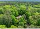 Panoramic aerial shot of a secluded home nestled amidst lush greenery and trees at 3915 Nottaway Rd, Durham, NC 27707