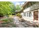 Well-manicured backyard with stone pathway, garden, and view of home exterior at 3915 Nottaway Rd, Durham, NC 27707