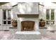 Outdoor brick fireplace with decorative planters and natural lighting at 3915 Nottaway Rd, Durham, NC 27707