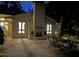 Outdoor patio with brick floor, fireplace, dining table, and lush greenery at 3915 Nottaway Rd, Durham, NC 27707