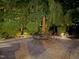 Outdoor patio with brick floor, dining table with umbrella, and lush greenery at 3915 Nottaway Rd, Durham, NC 27707