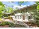 Landscaped backyard featuring a stone path and the exterior of the home at 3915 Nottaway Rd, Durham, NC 27707