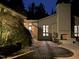 Outdoor patio with brick floor, fireplace and lush greenery at 3915 Nottaway Rd, Durham, NC 27707
