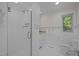 Bright white bathroom features glass enclosed shower and white ceramic tile at 3915 Nottaway Rd, Durham, NC 27707