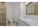 Bathroom features white vanity with marble countertop and detailed framed mirror at 3915 Nottaway Rd, Durham, NC 27707