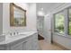 Bright bathroom featuring a vanity with marble countertop and ornate mirror at 3915 Nottaway Rd, Durham, NC 27707