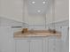 Bright bathroom vanity with custom cabinets and granite countertop under large mirror at 3915 Nottaway Rd, Durham, NC 27707