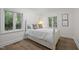Cozy bedroom featuring a white bed with storage underneath and two windows offering natural light at 3915 Nottaway Rd, Durham, NC 27707