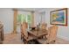 Charming dining room featuring a wooden table, six chairs, and a sunny window at 3915 Nottaway Rd, Durham, NC 27707