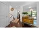Elegant foyer featuring dark hardwood floors, staircase, decorative mirror, and antique chest of drawers at 3915 Nottaway Rd, Durham, NC 27707
