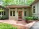 Charming front entrance with a brick patio and vibrant green landscaping at 3915 Nottaway Rd, Durham, NC 27707