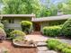 Front exterior of home featuring lush landscaping, a brick walkway, and a well-maintained lawn at 3915 Nottaway Rd, Durham, NC 27707