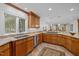 Well-equipped kitchen with wood cabinets, granite countertops, stainless steel appliances, and tile floors at 3915 Nottaway Rd, Durham, NC 27707