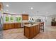 Spacious kitchen with wood cabinetry, stainless steel appliances, and a granite-topped center island at 3915 Nottaway Rd, Durham, NC 27707