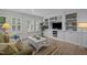 Bright living room offers custom built-ins, plantation shutters, and stylish decor at 3915 Nottaway Rd, Durham, NC 27707