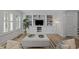 Stylish living room featuring custom built-ins, natural light, and hardwood floors at 3915 Nottaway Rd, Durham, NC 27707