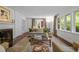 Spacious living room with stylish furniture, fireplace, and windows to the outside at 3915 Nottaway Rd, Durham, NC 27707