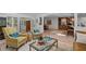 Inviting living room with comfortable seating, tiled floors, and seamless flow to dining room at 3915 Nottaway Rd, Durham, NC 27707