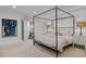 Large main bedroom with a canopy bed and soft carpet, and an en suite bath at 3915 Nottaway Rd, Durham, NC 27707