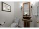 Unique powder room features a rustic vanity with a vessel sink and ornate mirror at 3915 Nottaway Rd, Durham, NC 27707