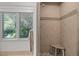 Modern tiled shower with a built-in seat and glass door provides comfort at 3915 Nottaway Rd, Durham, NC 27707