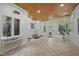 Inviting sunroom offering natural light, tiled floors, and views of the surrounding landscape at 3915 Nottaway Rd, Durham, NC 27707