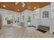 Bright sunroom featuring a wood ceiling, tiled flooring, and access to the backyard at 3915 Nottaway Rd, Durham, NC 27707