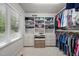 Spacious walk-in closet with built-in shelves and ample storage for clothing and shoes at 3915 Nottaway Rd, Durham, NC 27707