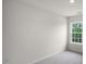 Cozy bedroom with a window providing natural light and neutral carpet flooring at 400 Ember St, Sanford, NC 27330