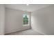 Clean bedroom with window providing natural light, carpet flooring, and fresh, white walls at 400 Ember St, Sanford, NC 27330