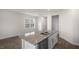 Eat-in kitchen with a large island, stainless steel appliances, and luxury vinyl plank flooring at 400 Ember St, Sanford, NC 27330