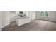 Open concept kitchen with stainless steel appliances, large windows, and access to the dining room at 400 Ember St, Sanford, NC 27330