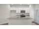 Modern kitchen with white cabinets, granite counters, stainless appliances, and ample counter space on large island at 400 Ember St, Sanford, NC 27330