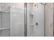 Modern shower features sleek white tile and glass door, offering a spa-like experience at 400 Ember St, Sanford, NC 27330