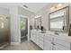 Bathroom featuring double sink vanity and enclosed glass shower at 402 Troycott Pl, Cary, NC 27519