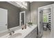 Bathroom featuring double sinks, white cabinets, an expansive mirror, and a separate toilet room at 402 Troycott Pl, Cary, NC 27519