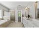 Spacious bathroom with a soaking tub and a white double sink vanity at 402 Troycott Pl, Cary, NC 27519