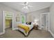 Cozy bedroom featuring neutral walls, ceiling fan, and an adjacent closet for organized storage at 402 Troycott Pl, Cary, NC 27519