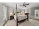 Bedroom featuring a four-poster bed, neutral tones, and natural light creating a tranquil and comfortable space at 402 Troycott Pl, Cary, NC 27519