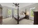 Spacious bedroom with a four-poster bed, neutral tones, and natural light creating a serene and inviting retreat at 402 Troycott Pl, Cary, NC 27519