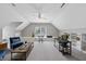 Expansive bonus room with vaulted ceiling and ample space for seating, desk, and musical instruments at 402 Troycott Pl, Cary, NC 27519